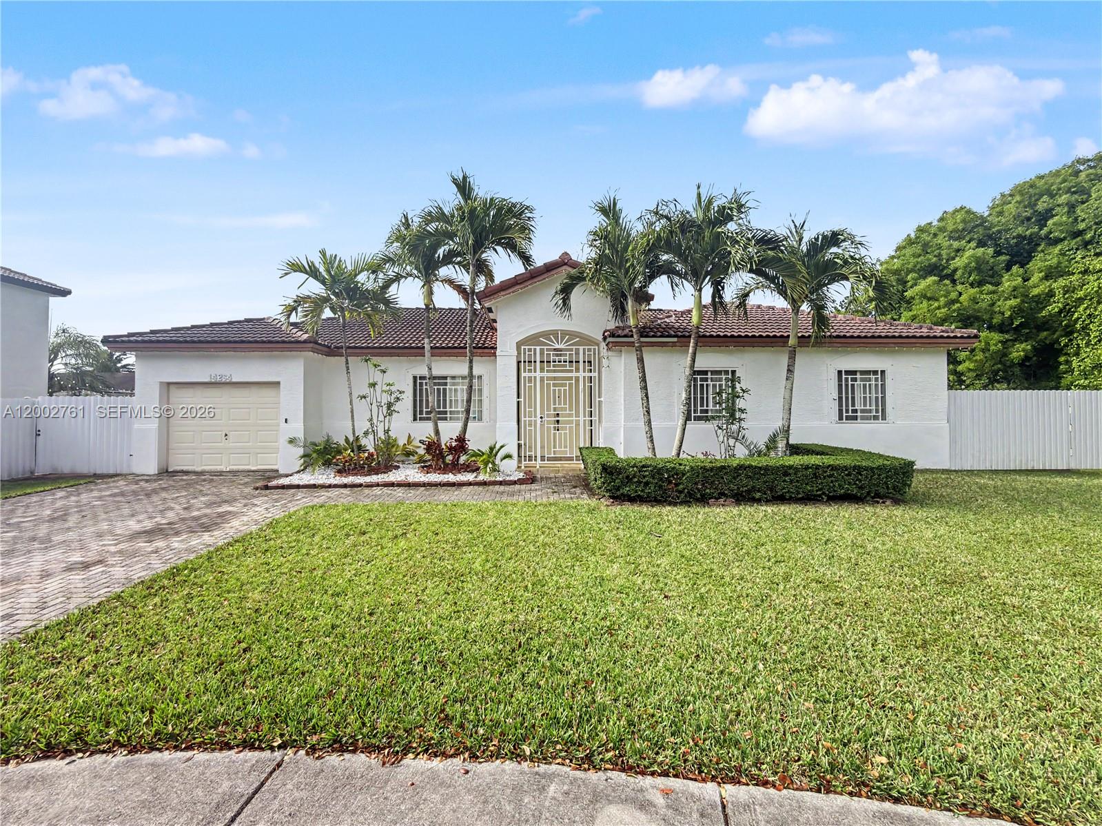 14264 Southwest 289th Terrace Homestead, FL 33033 - Photo 2 of 23 a front view of a house with garden