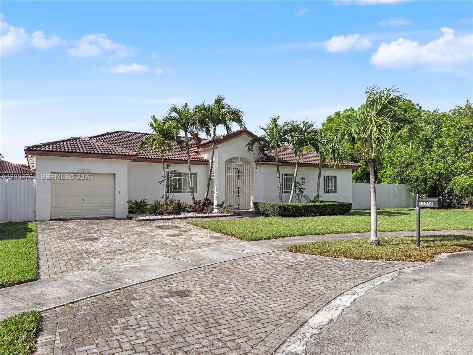 14264 Southwest 289th Terrace Homestead, FL 33033 - Photo 3 of 23 a front view of a house with a yard and garage