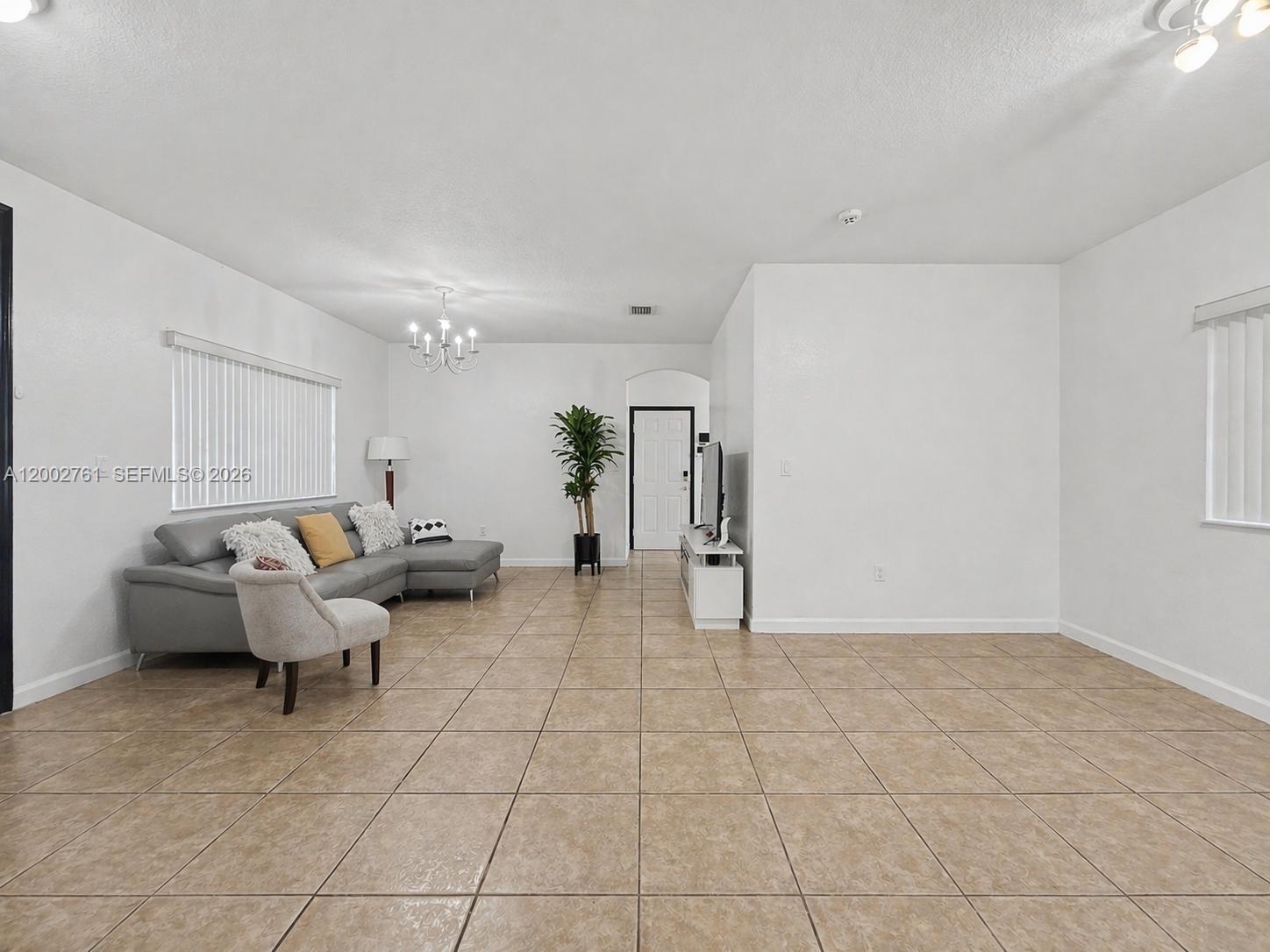 14264 Southwest 289th Terrace Homestead, FL 33033 - Photo 6 of 23 a living room with furniture and a table