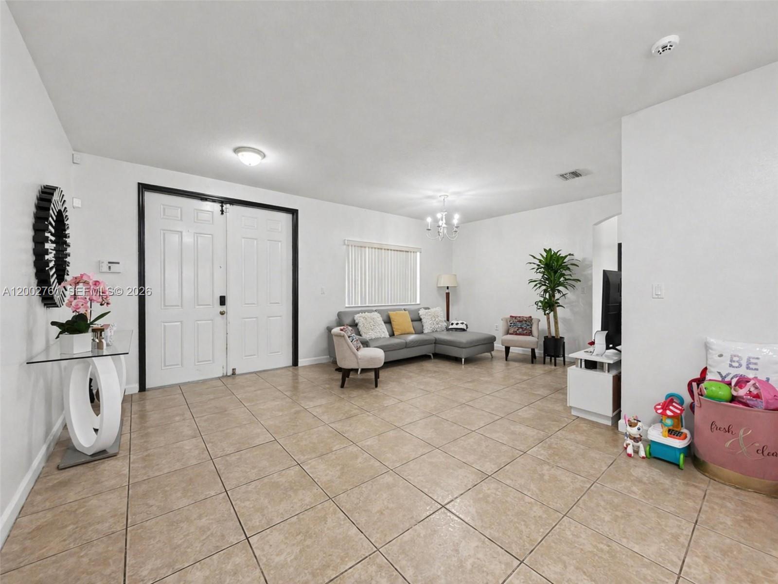 14264 Southwest 289th Terrace Homestead, FL 33033 - Photo 7 of 23 a living room with furniture and a potted plant