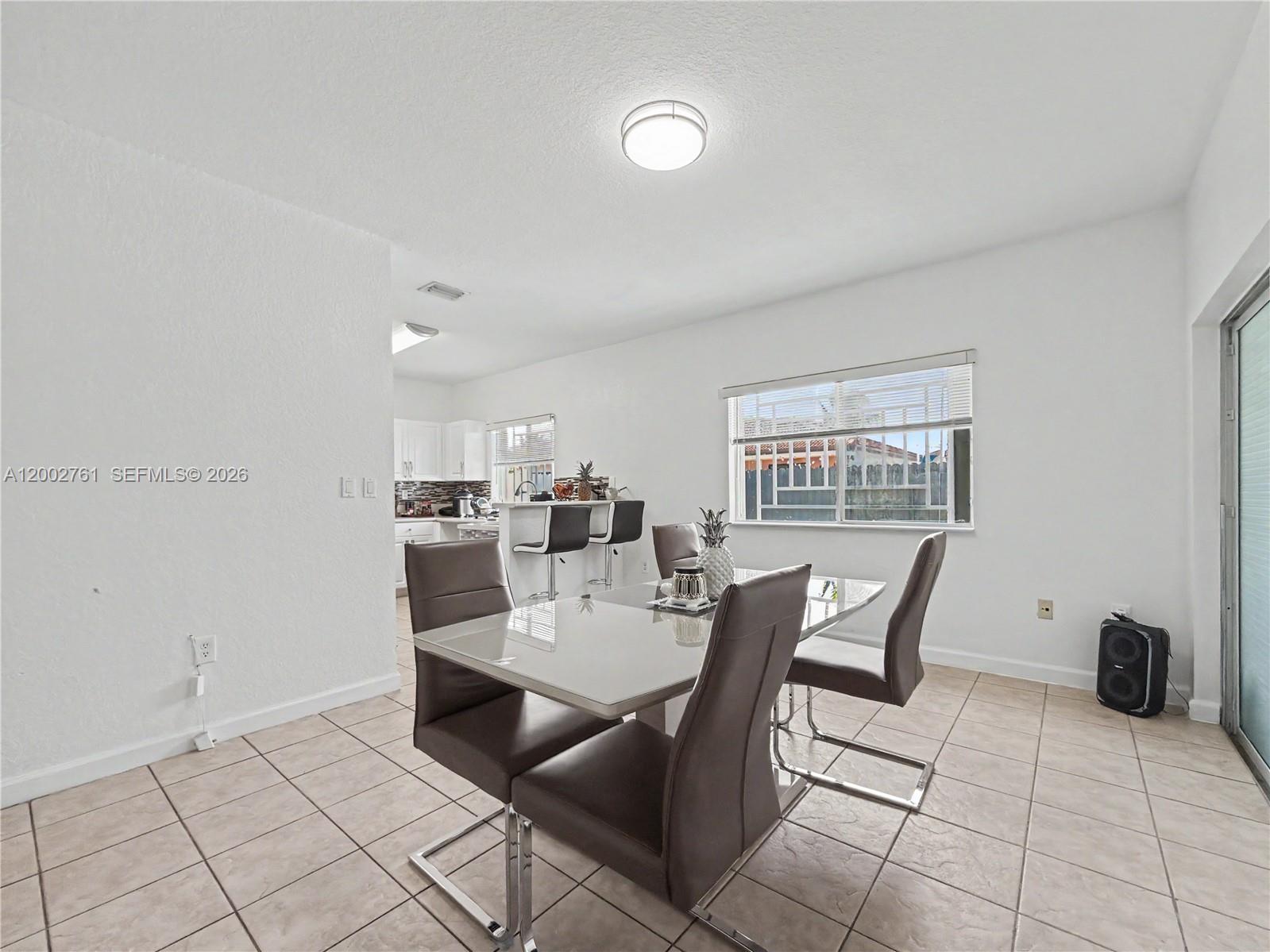 14264 Southwest 289th Terrace Homestead, FL 33033 - Photo 8 of 23 a dining room with a table and chairs