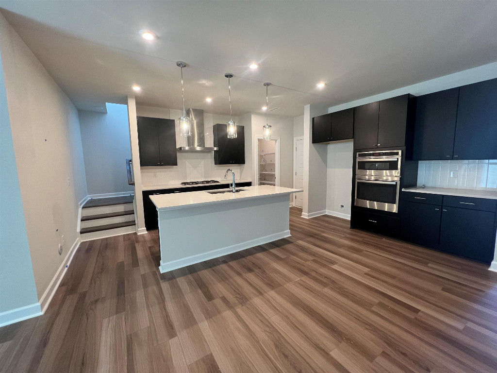 7809 Sofiana Avenue Raleigh, NC 27617 - Photo 14 of 20 a kitchen with stainless steel appliances a refrigerator and a stove top oven