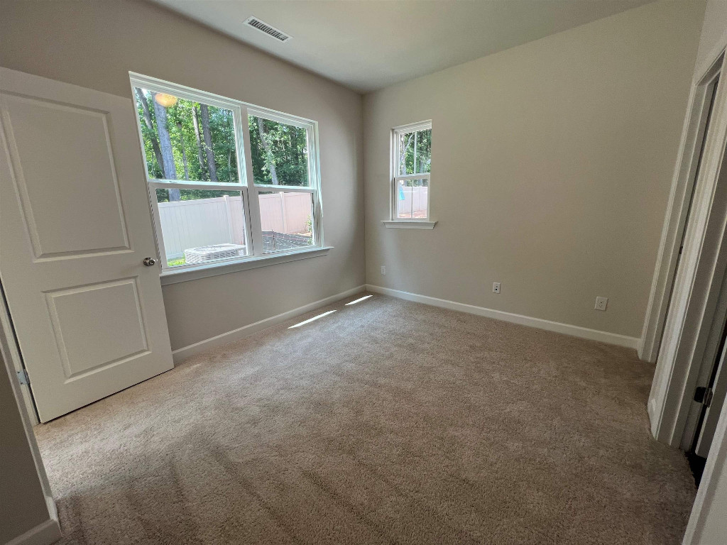 7809 Sofiana Avenue Raleigh, NC 27617 - Photo 16 of 20 an empty room with windows