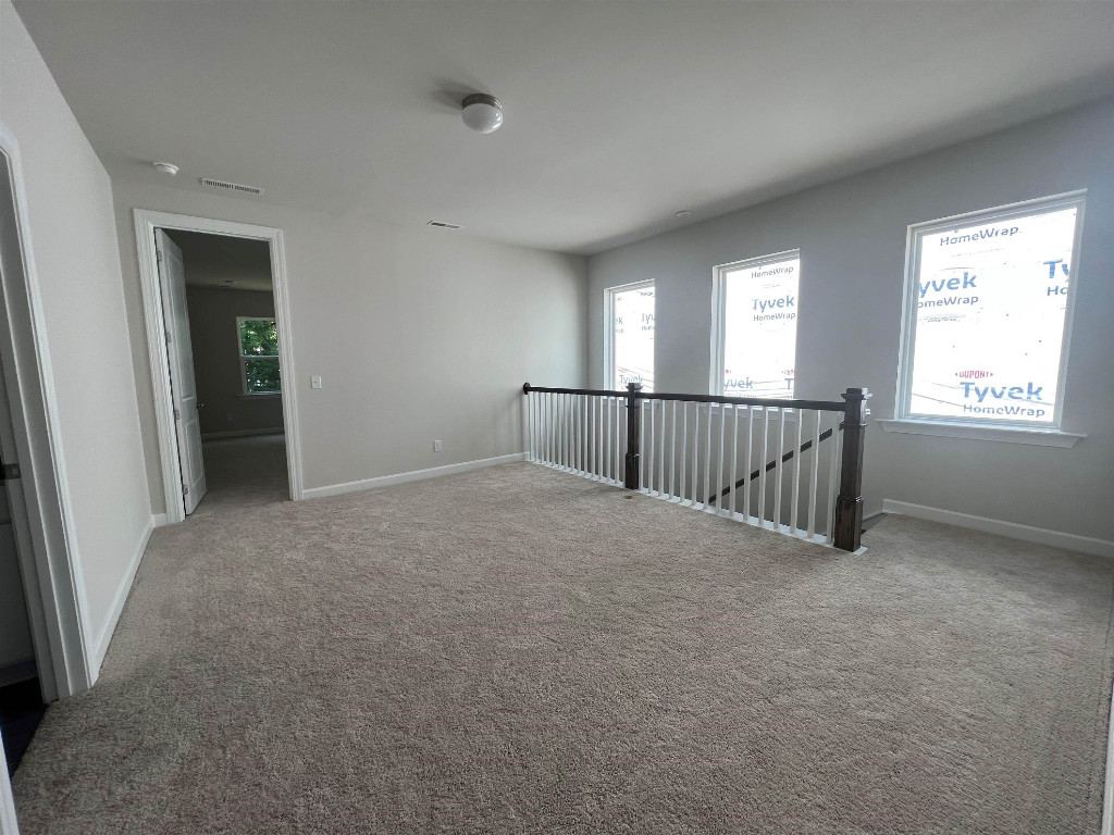 7809 Sofiana Avenue Raleigh, NC 27617 - Photo 19 of 20 an empty room with windows