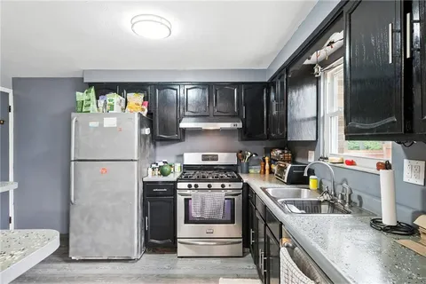 a kitchen with a refrigerator stove and sink