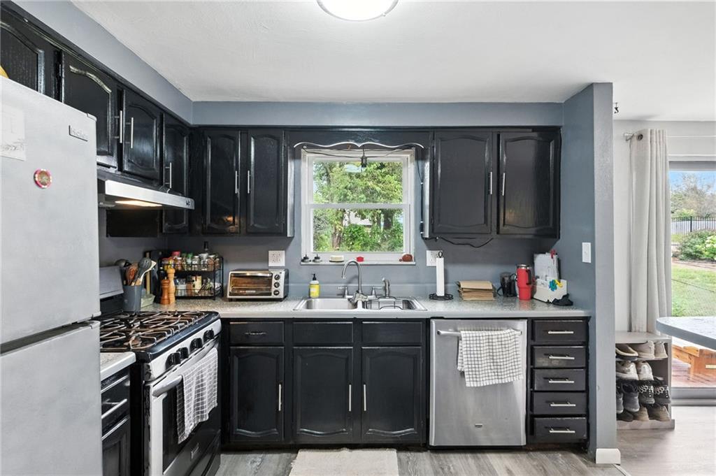 553 Indus Street Pittsburgh, PA 15207 - Photo 11 of 41 a kitchen with a sink stove and cabinets