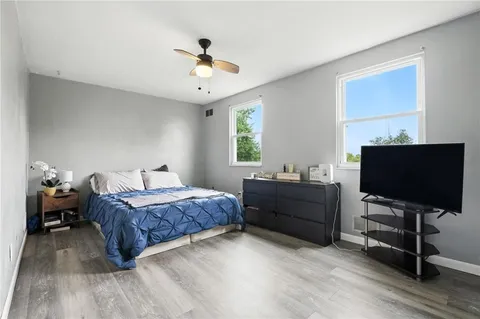 a bedroom with a bed and a flat screen tv