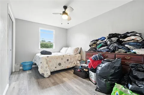 a bedroom with bed and a chandelier