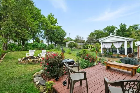 a view of a house with backyard sitting area and garden