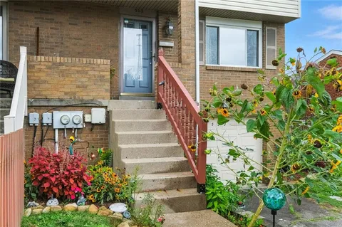 a view of a house with potted plants