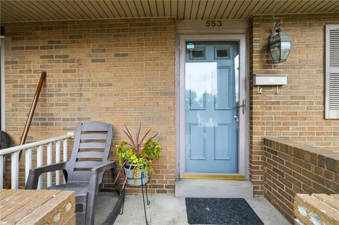 a view of a door and chair in the balcony