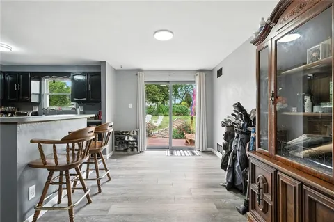 a dining room with furniture and a potted plant
