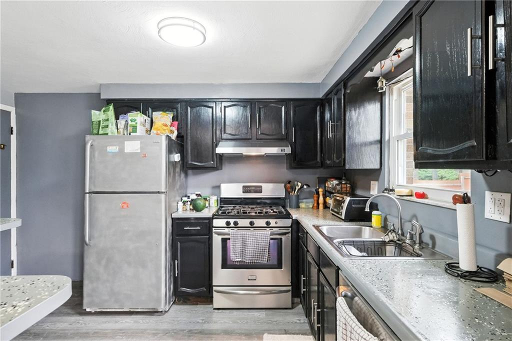 553 Indus Street Pittsburgh, PA 15207 - Photo 10 of 41 a kitchen with a refrigerator stove and sink