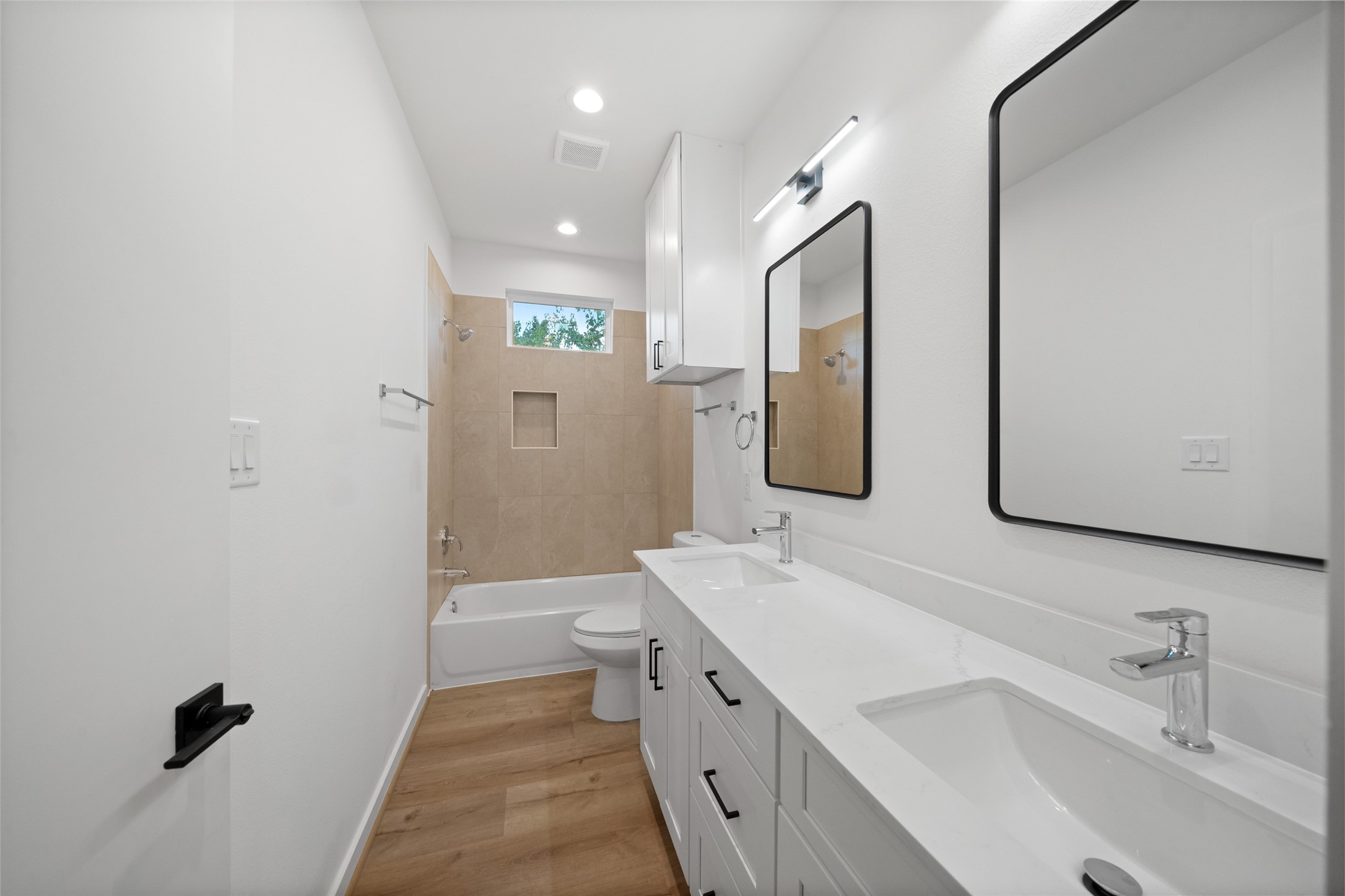 1408 Enid Street, Unit A Houston, TX 77009 - Photo 16 of 28 a bathroom with a double vanity sink mirror and bathtub