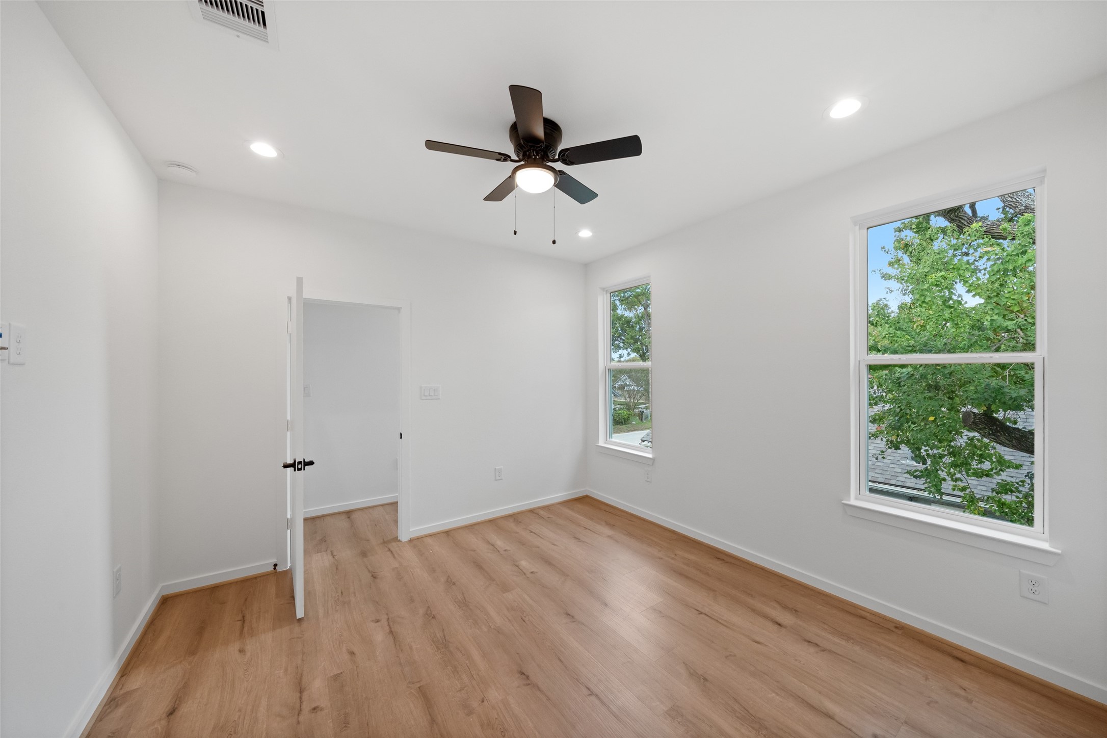 1408 Enid Street, Unit A Houston, TX 77009 - Photo 17 of 28 a view of empty room with wooden floor and fan
