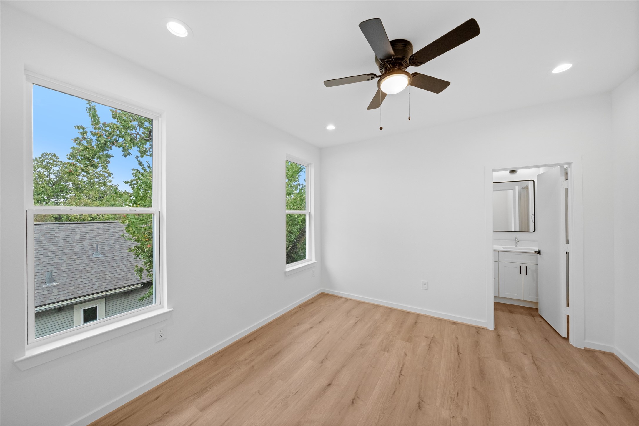 1408 Enid Street, Unit A Houston, TX 77009 - Photo 18 of 28 a view of an empty room with a window and wooden floor