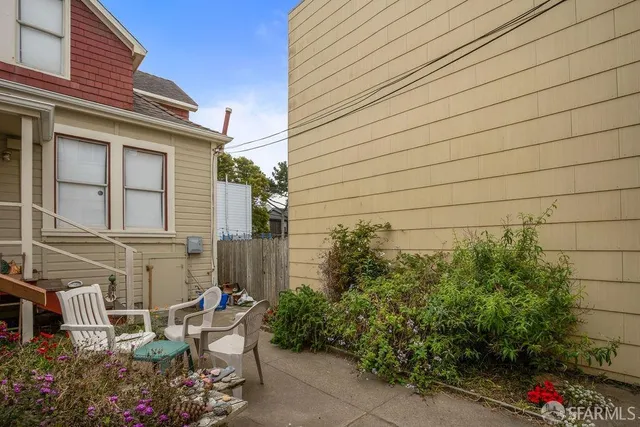 a view of a patio with table and chairs and potted plants
