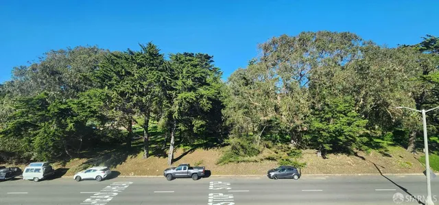 a view of a street along with trees