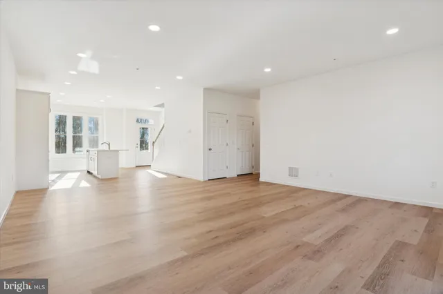 a kitchen with stainless steel appliances a stove microwave and sink