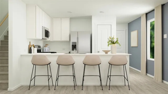 a view of kitchen with furniture and wooden floor