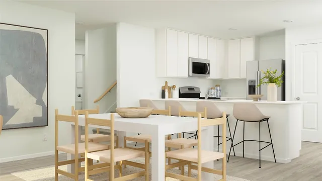 a kitchen with a dining table and chairs