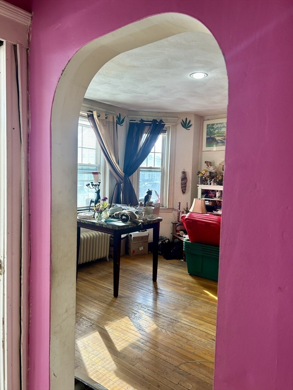 110 Bellingham Street, Unit 1 Chelsea, MA 02150 - Photo 13 of 17 a living room with furniture and a wooden floor