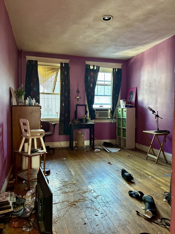 110 Bellingham Street, Unit 1 Chelsea, MA 02150 - Photo 14 of 17 a room with furniture and a wooden floor