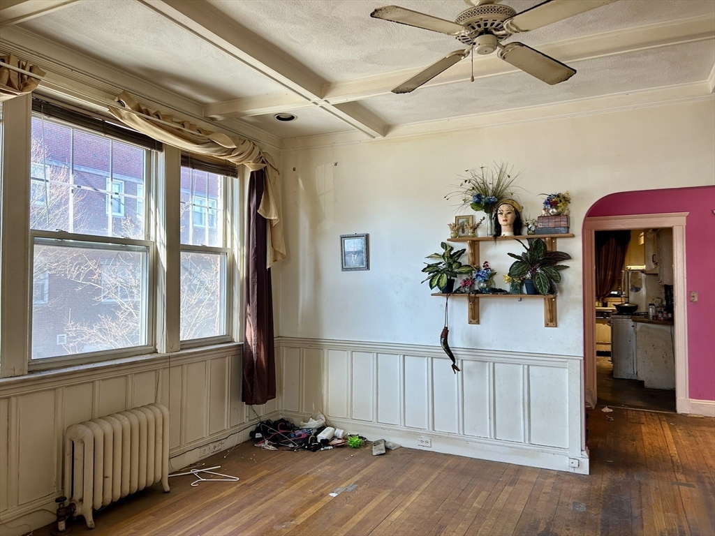 110 Bellingham Street, Unit 1 Chelsea, MA 02150 - Photo 10 of 17 a view of a livingroom with wooden floor and a staircase