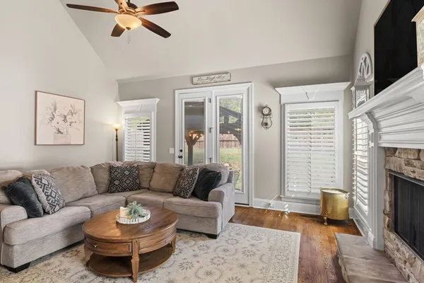 a living room with furniture a fireplace and a flat screen tv