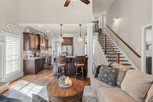 a living room with lots of furniture and kitchen view