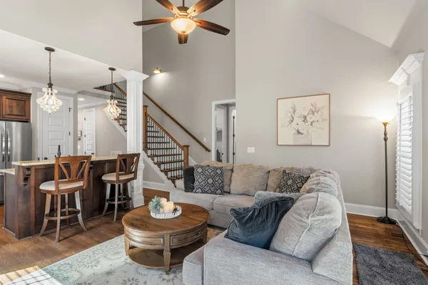 a living room with furniture and a wooden floor