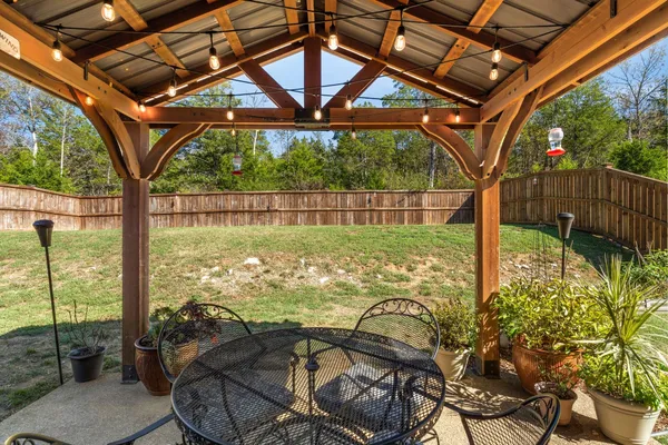 a view of a house with yard and sitting area