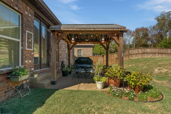 a view of a house with garden and sitting area