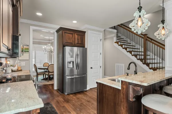 a kitchen with sink refrigerator and microwave