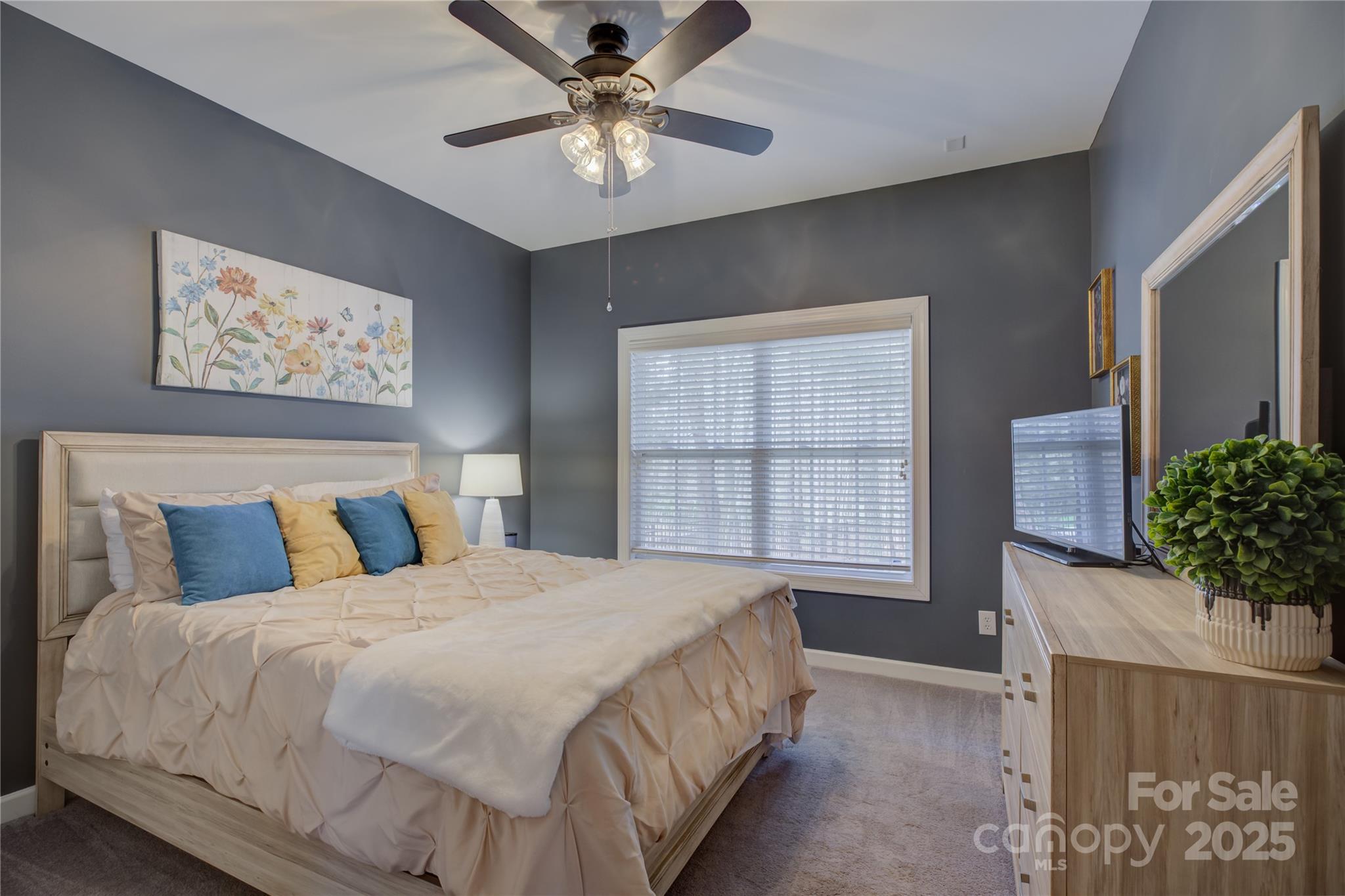 16645 Turtle Point Road Charlotte, NC 28278 - Photo 11 of 48 a bedroom with a bed and a chandelier