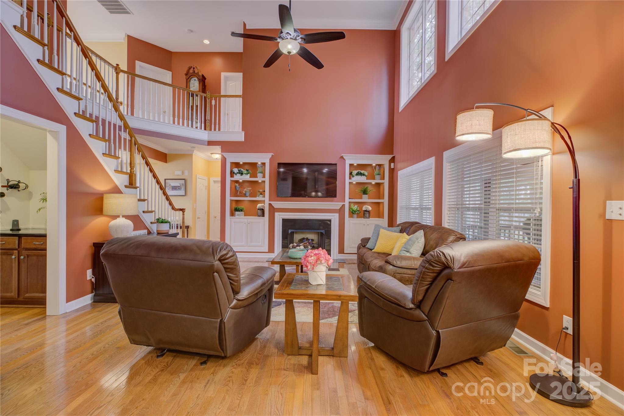 16645 Turtle Point Road Charlotte, NC 28278 - Photo 14 of 48 a living room with furniture a fireplace and a flat screen tv