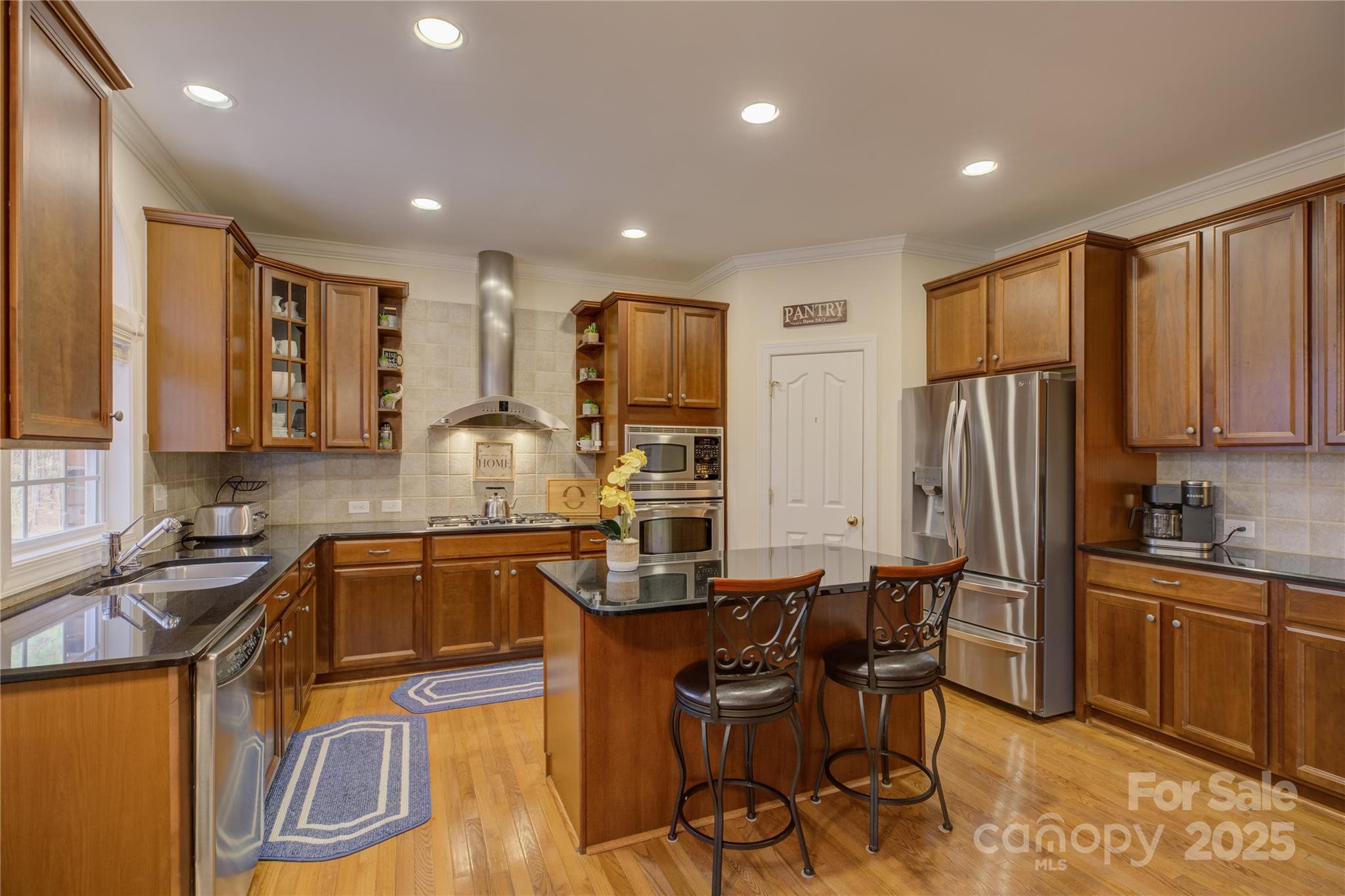 16645 Turtle Point Road Charlotte, NC 28278 - Photo 16 of 48 a kitchen with granite countertop a sink stove and refrigerator