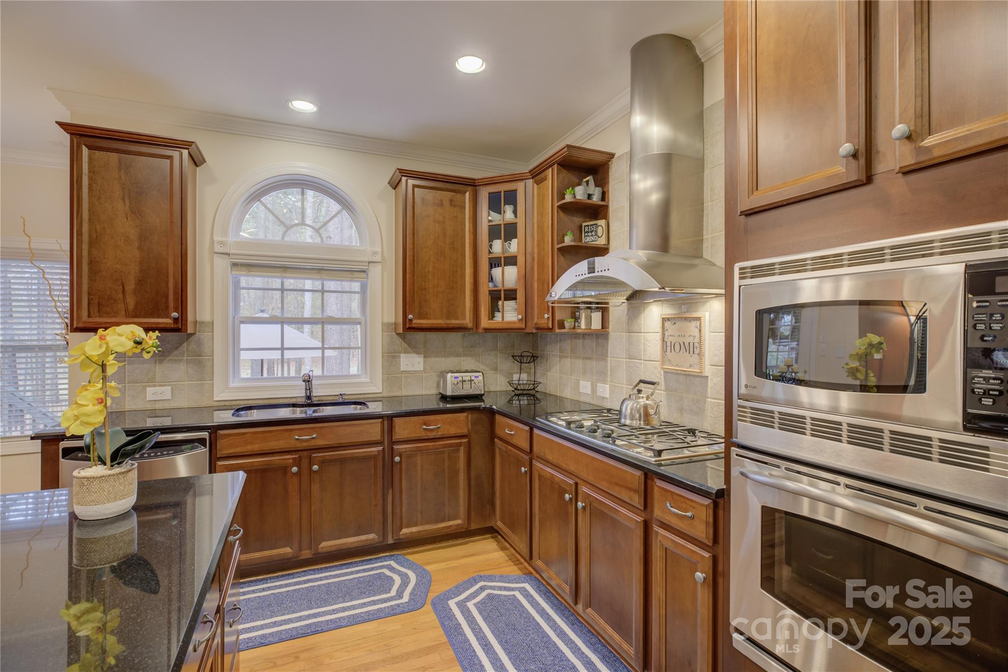 16645 Turtle Point Road Charlotte, NC 28278 - Photo 17 of 48 a kitchen with stainless steel appliances a sink stove and cabinets