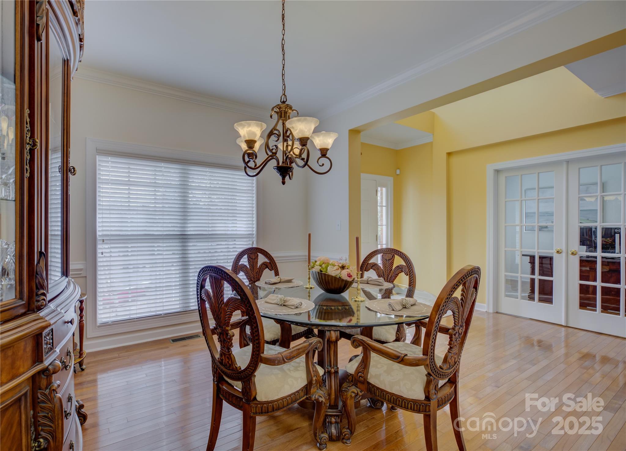 16645 Turtle Point Road Charlotte, NC 28278 - Photo 9 of 48 a dining room with furniture a chandelier and wooden floor