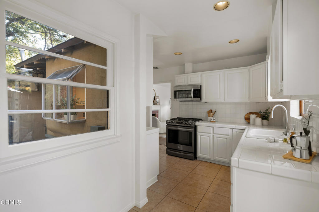 3624 Canyon Crest Road Altadena, CA 91001 - Photo 24 of 57 a kitchen with stainless steel appliances granite countertop a refrigerator sink and stove