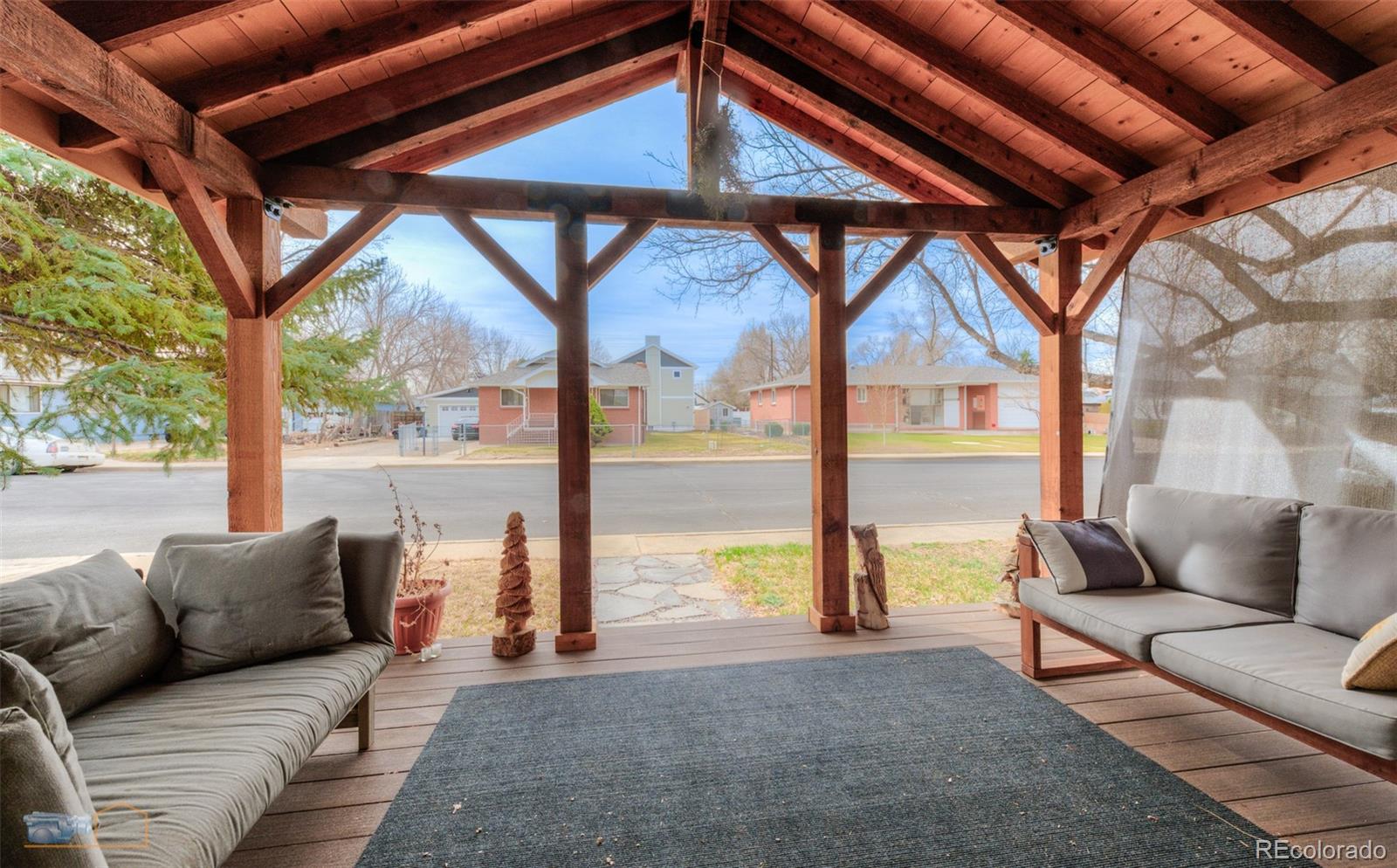 329 2nd Street Frederick, CO 80530 - Photo 37 of 49 a living room with furniture and a floor to ceiling window next to a yard