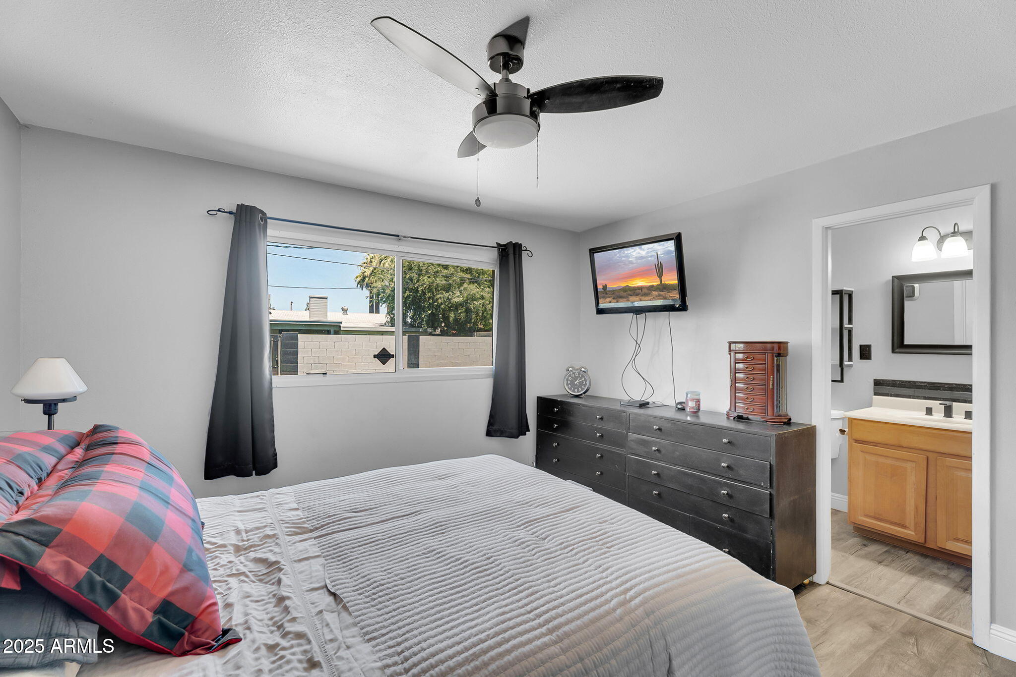 122 East Hermosa Drive Tempe, AZ 85282 - Photo 11 of 30 a bedroom with a bed and a chandelier