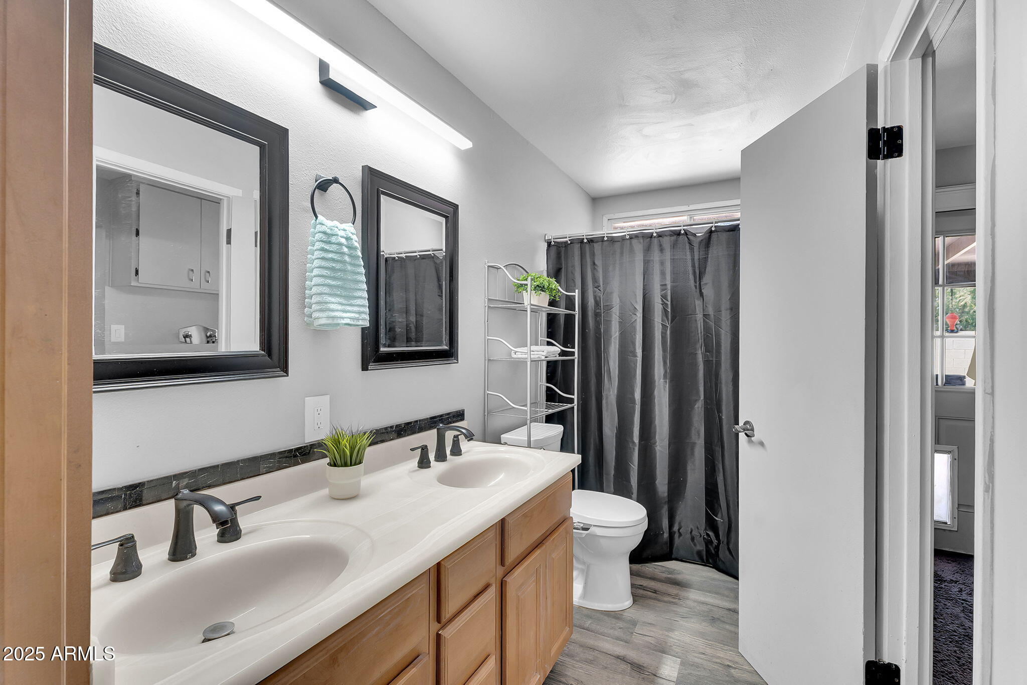 122 East Hermosa Drive Tempe, AZ 85282 - Photo 12 of 30 a bathroom with a double vanity sink mirror and shower