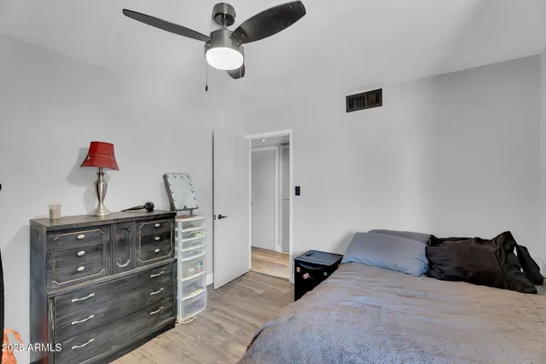 a bedroom with a bed and a dresser