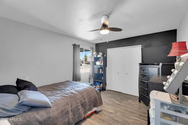 a bedroom with a bed and wooden floor