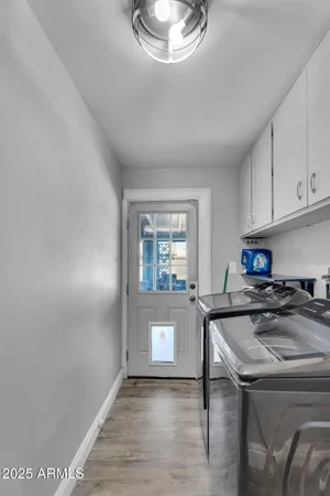 a kitchen with a sink a stove cabinets and a window