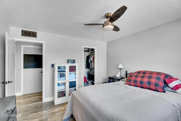 a bedroom with a bed and a television