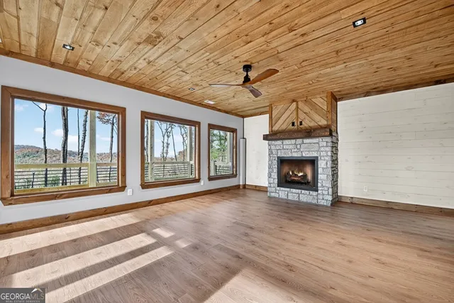a view of a hallway with wooden floor and entryway