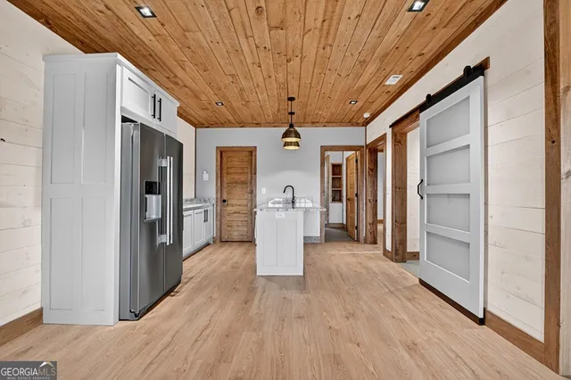 a kitchen with granite countertop a sink cabinets stainless steel appliances and a granite counter tops