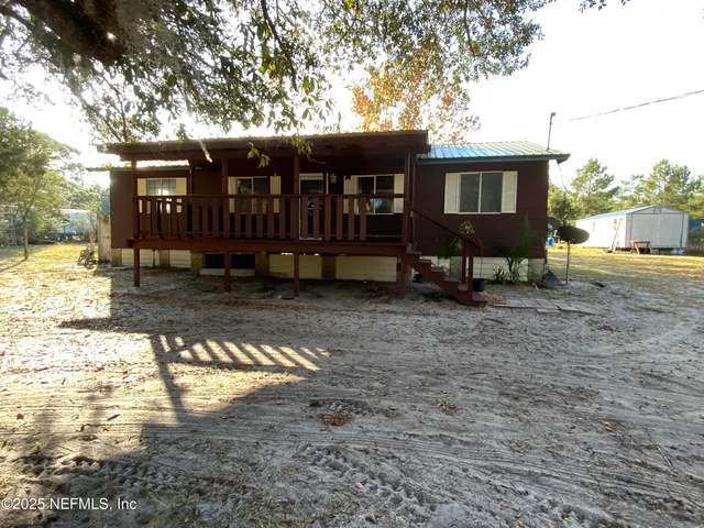 a view of a house with backyard porch and sitting area